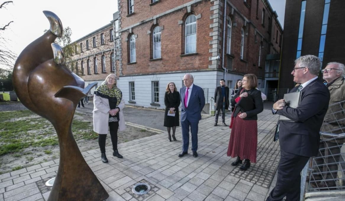 photograph of people around the Teachers Inspire Sculpture